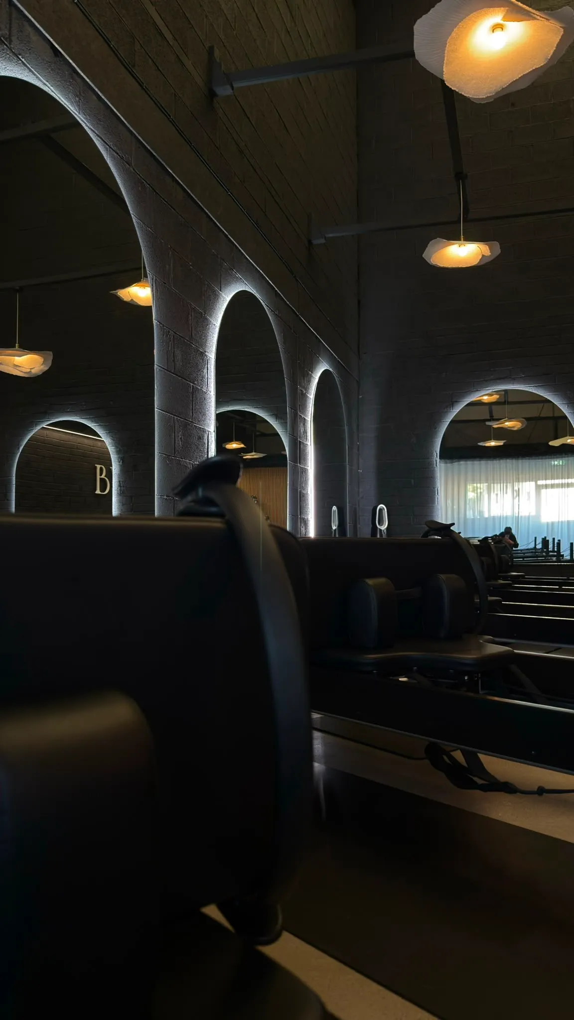 Glowing arches and pendant lights above the reformers in Kilcullen