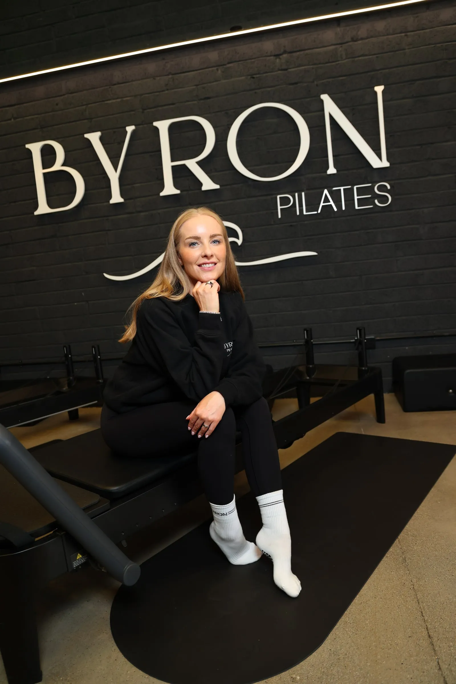 BYRON's founder sitting on a reformer in the Kilcullen studio