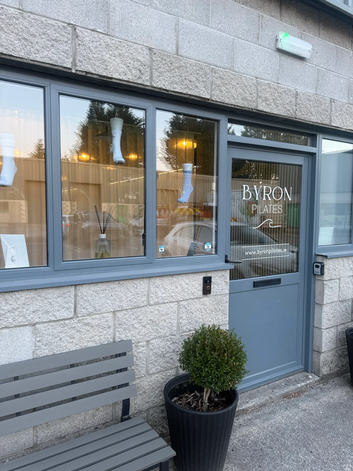 The front door of BYRON Pilates Kilcullen, with the BYRON wave on the glass