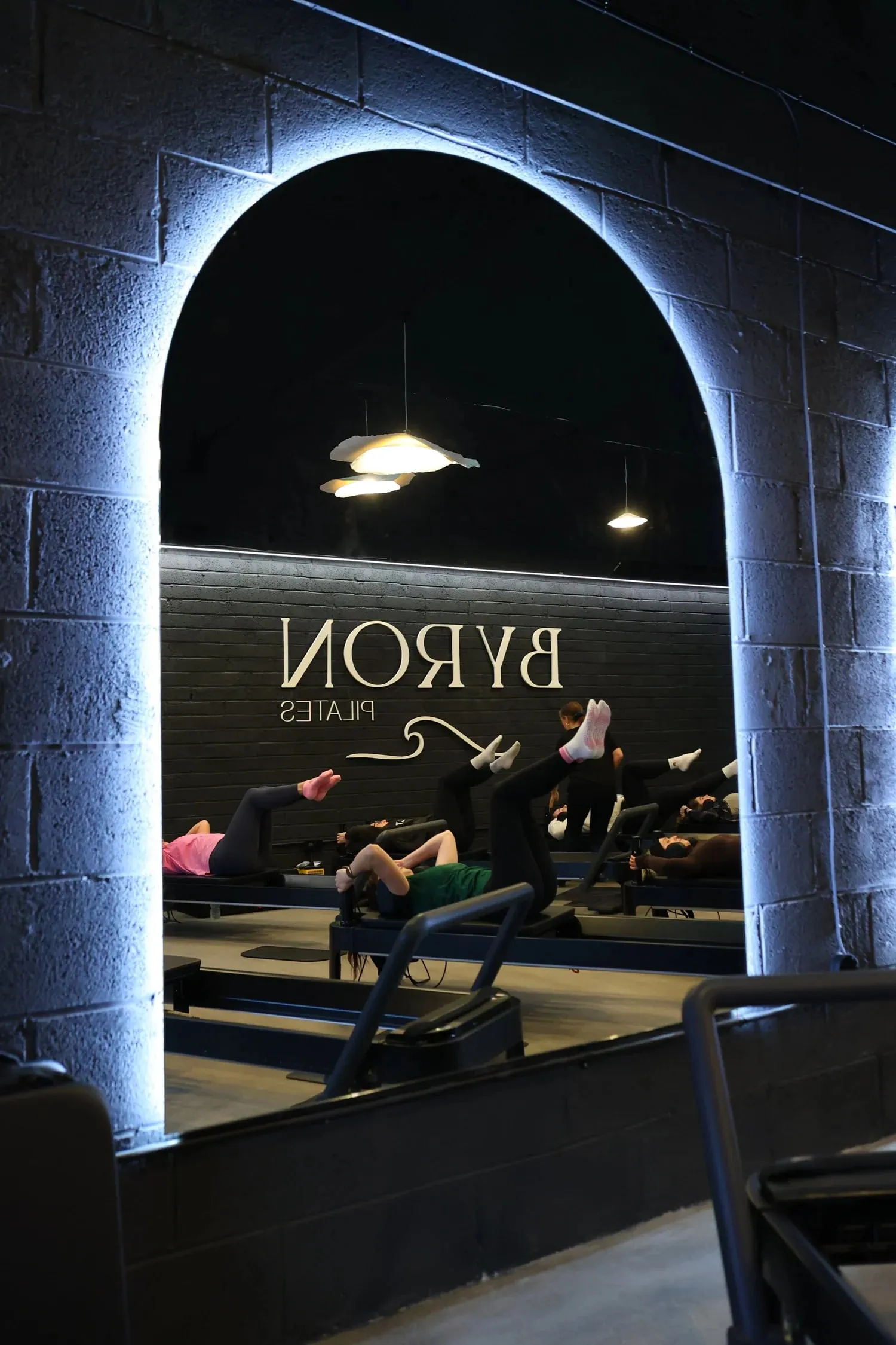 An advanced class working beneath the neon-lit arch